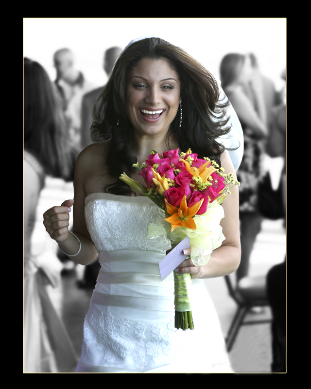Bride smiling with a colorful bouquet
